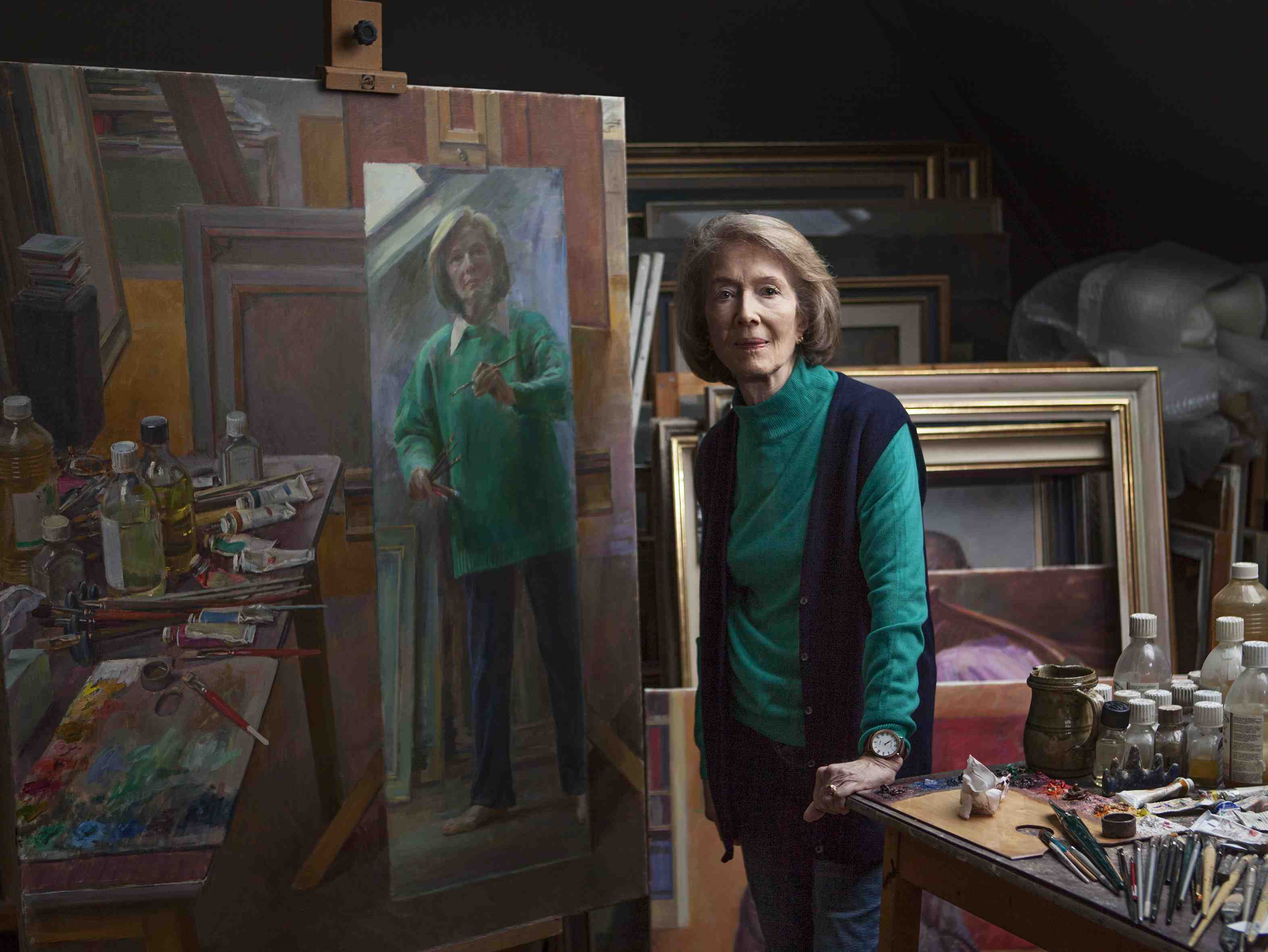 June Mendoza in her studio photographed by Aliona Adrianova Portrait artist June Mendoza standing by her easel in her studio photographed by Aliona Adrianova